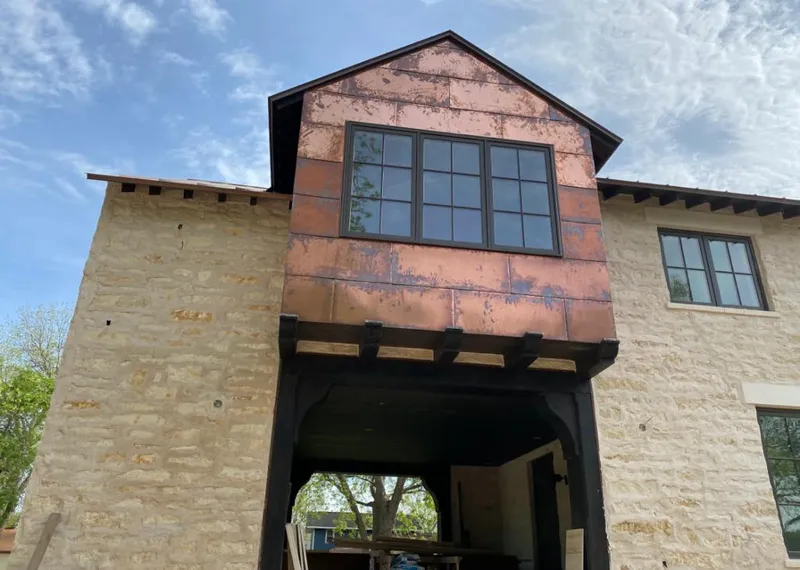 Copper metal panel facade on a stone building for Roof Repair in Rio Grande City