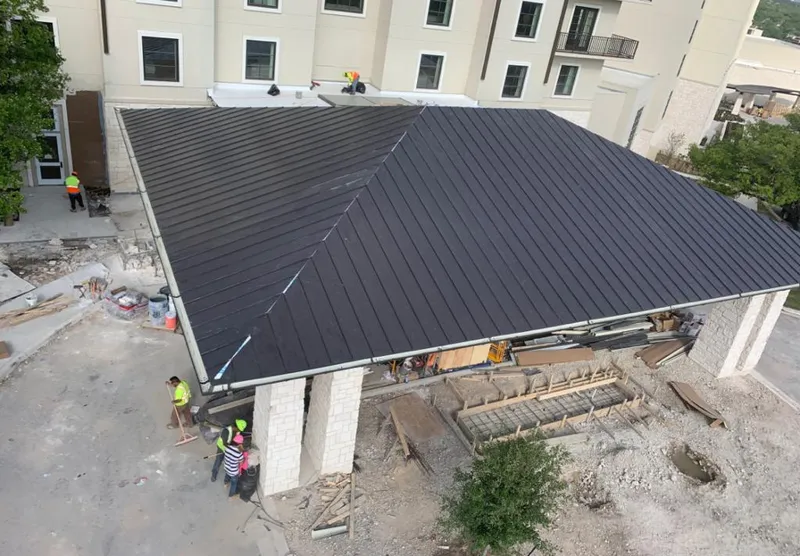 Metal roofing installation team working on a commercial building in Rio Grande City